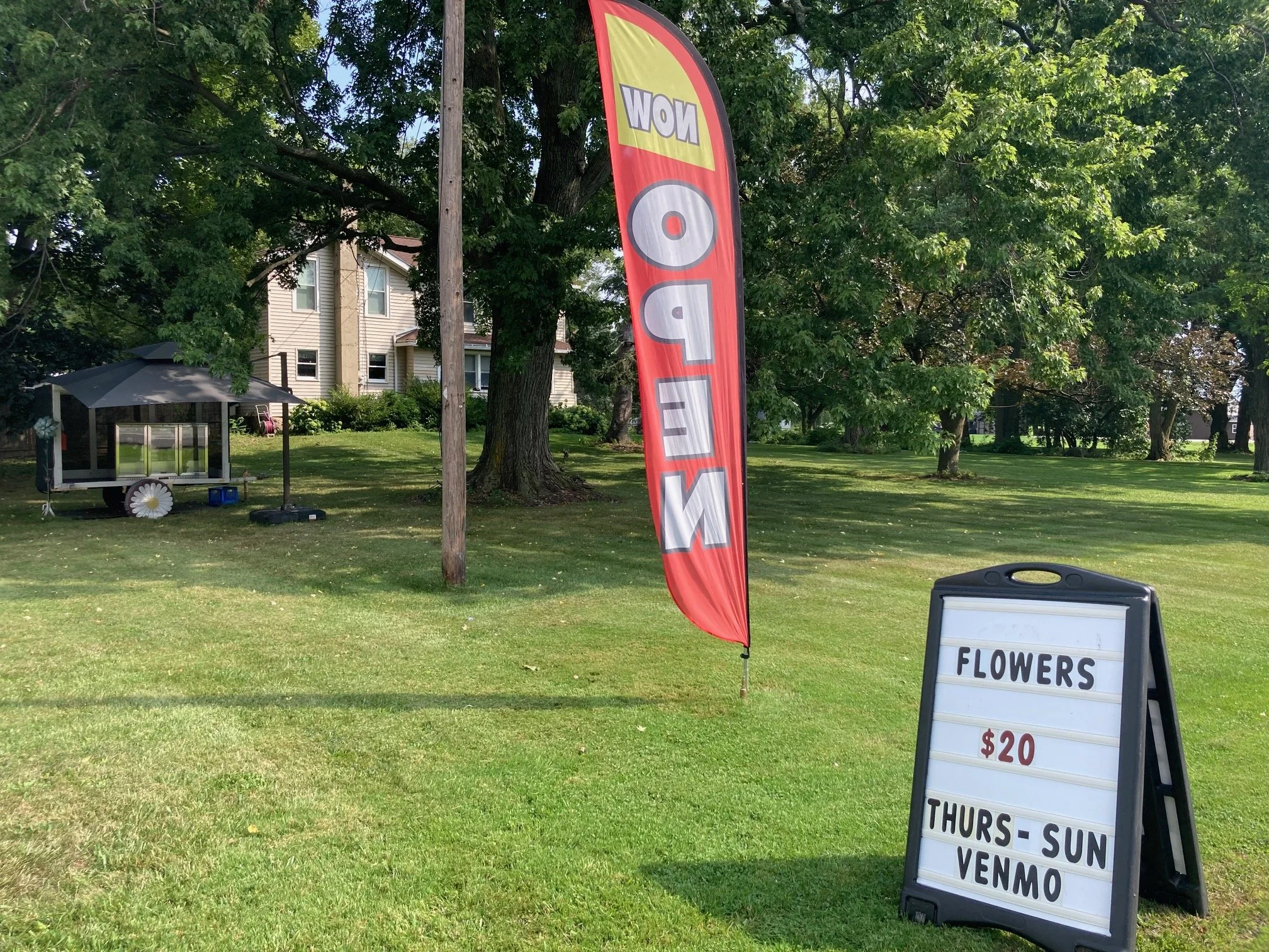 feather flag and sign at the roadside