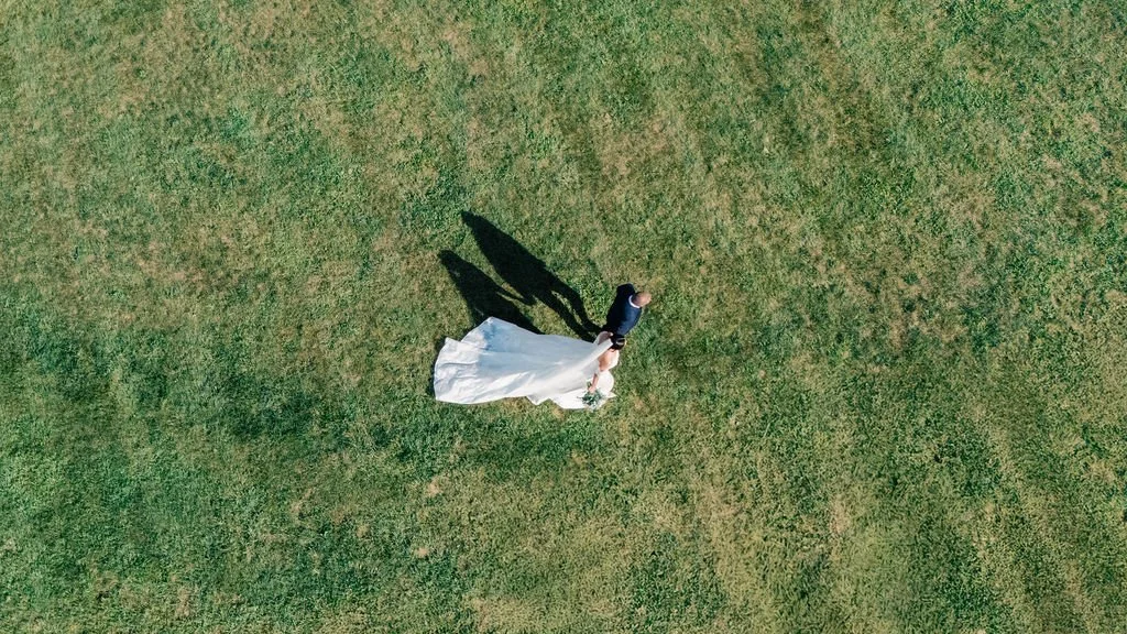 Laurie’s customers, Larissa and Emmett, just married walking off the aisle together.