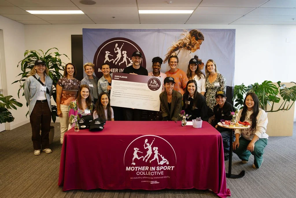 Mother in Sport Collective founding member representatives pose with the signed pledhe