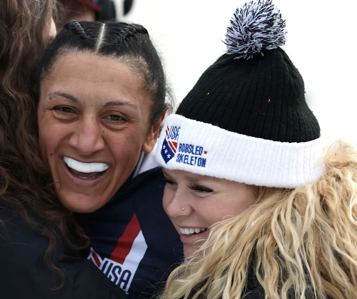 Elana Meyers Taylor hugs her children's nanny after winning a gold medal at the Winter Olympics