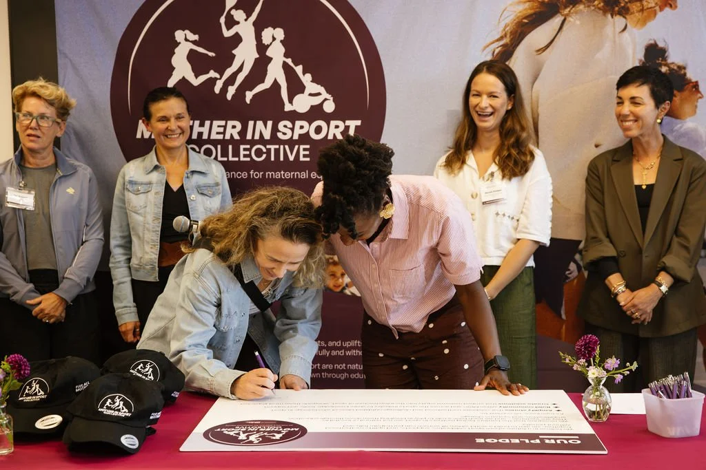 Alysia Montaño (FAM+), Nicole Kleppe (HOKA),  Magdalena Lewis-Boulet (GU Energy Labs), and Brooke Donberg (CLIF) sign the Mother in Sport Collective pledge 