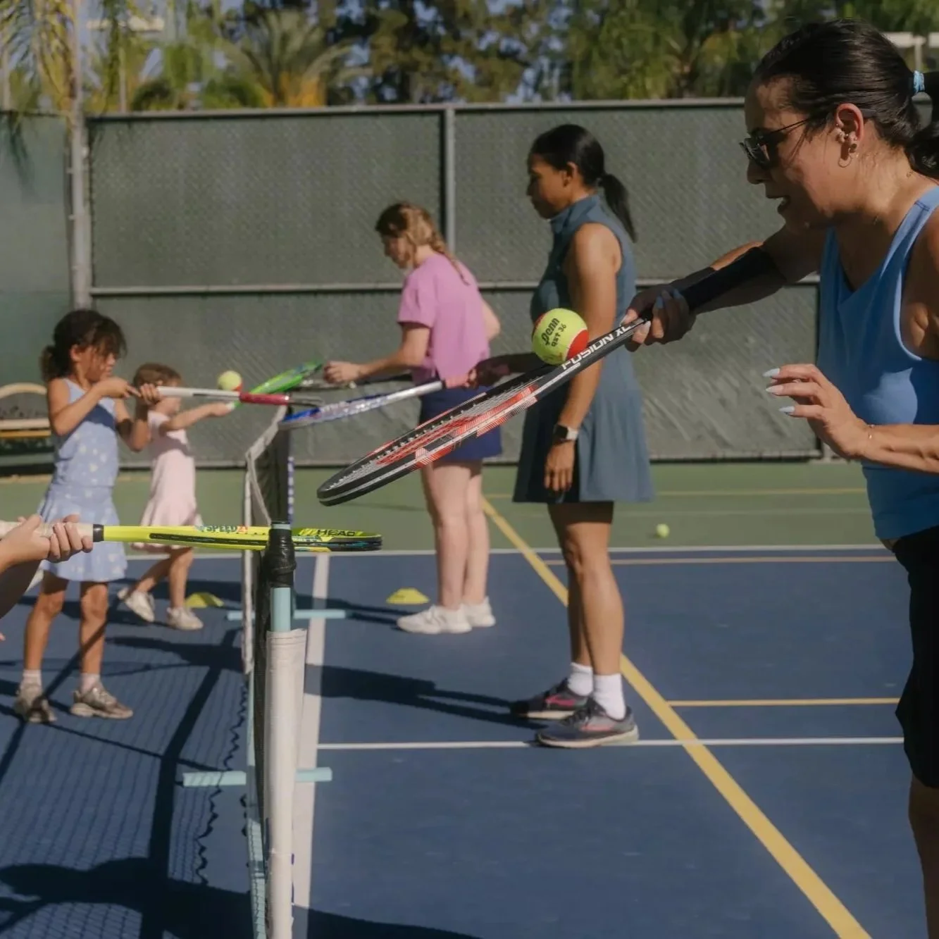 Jacqueline Castro runs tennis drills with her daughter, Ruby, 5, during a Mommy & Me tennis class at Burbank Tennis Club.