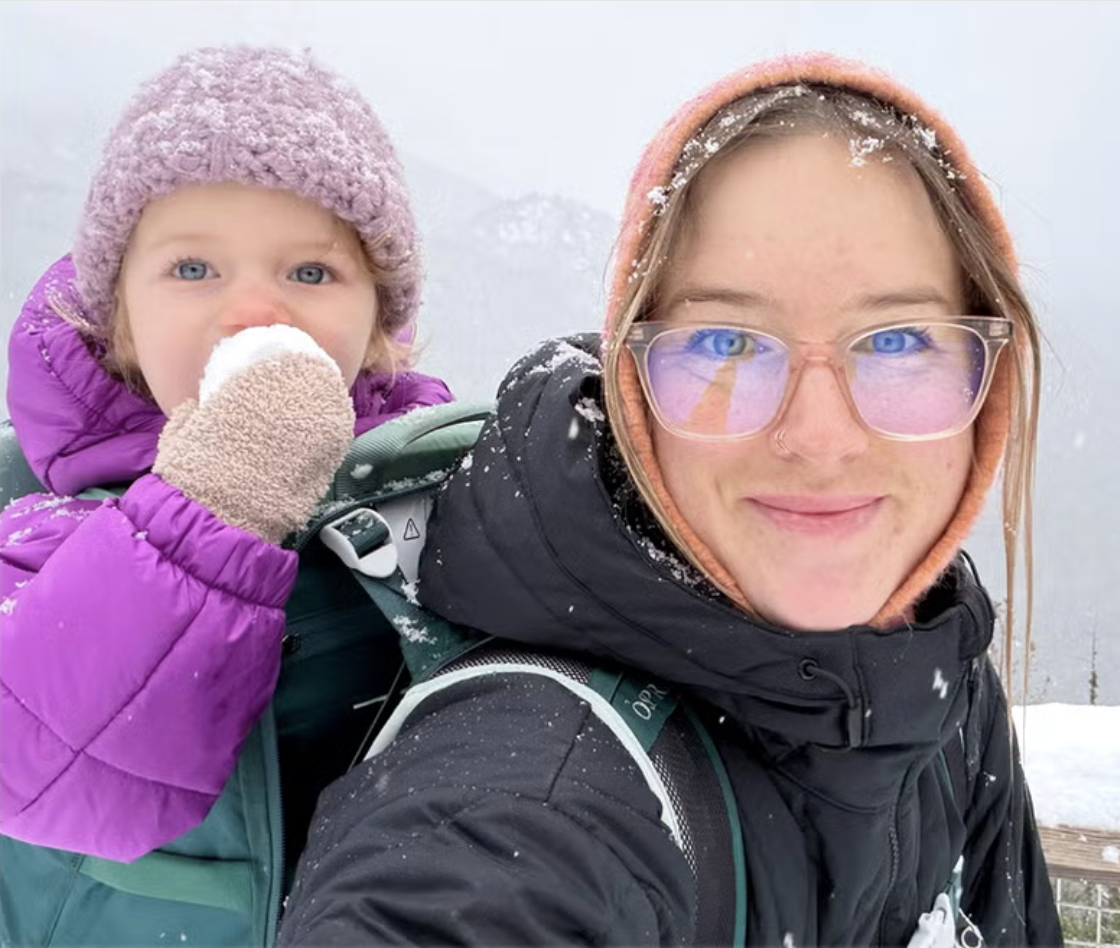 Canadian Winter Olympian Cassie Sharpe poses with her baby outdoors in the snow