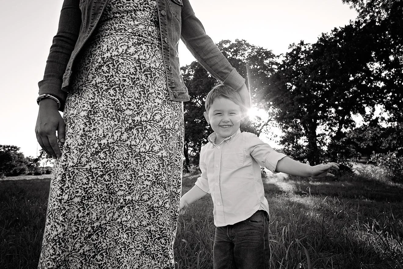 Little boy with his mother smiling in the field.jpg