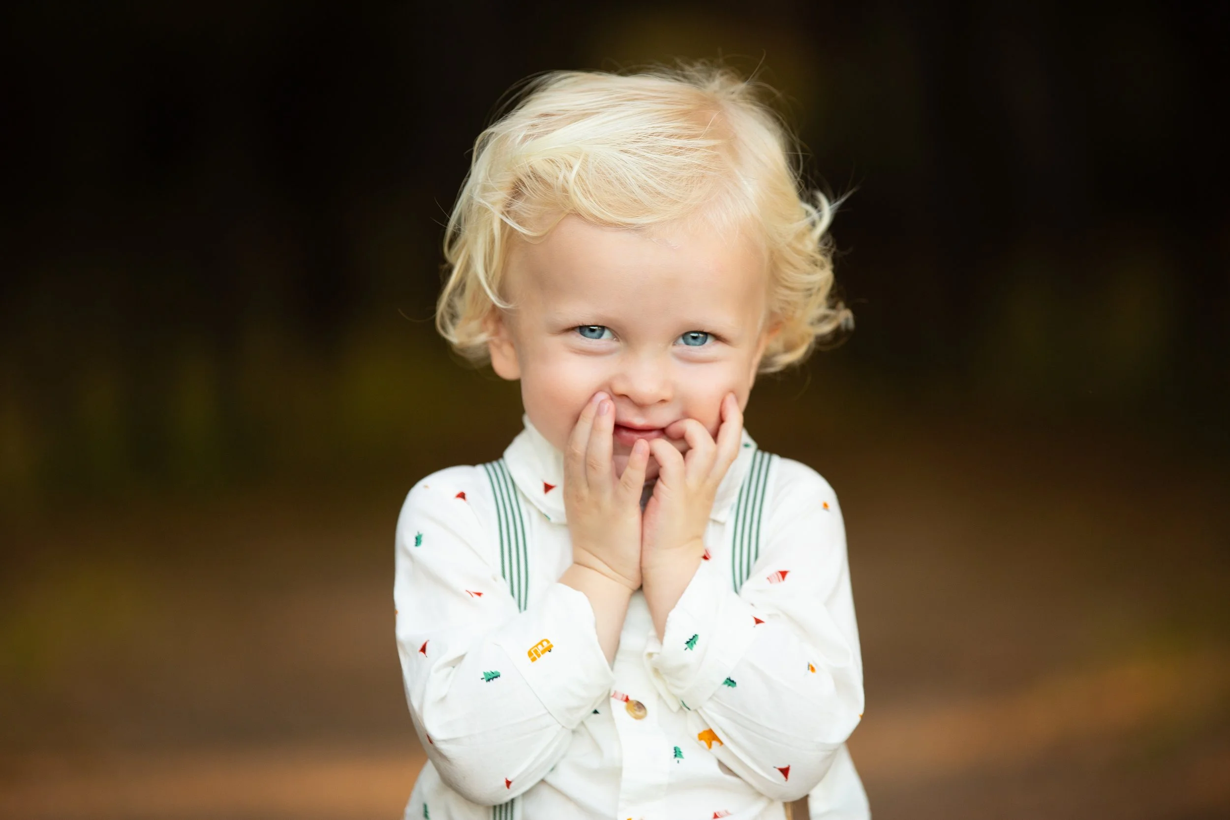 Darling-colorful-image-of-a-bashful-little-blond-boy-with-suspenders-from-a-professional-family-photo-shoot-near-Southlake-Texas.jpg