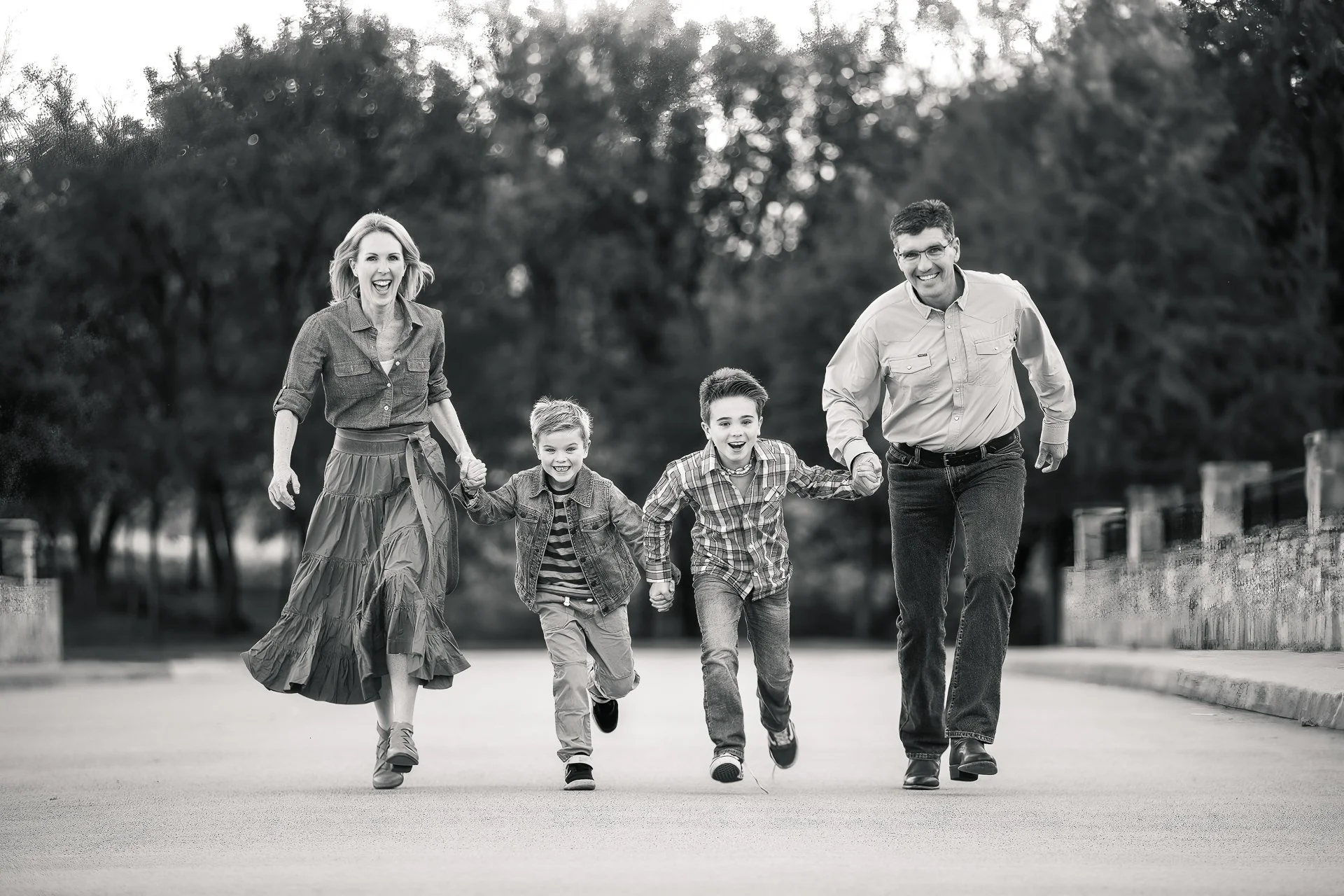 black-and-white-image-of-a-family-running-and-laughing-near-Trophy-Club-Texas.jpg