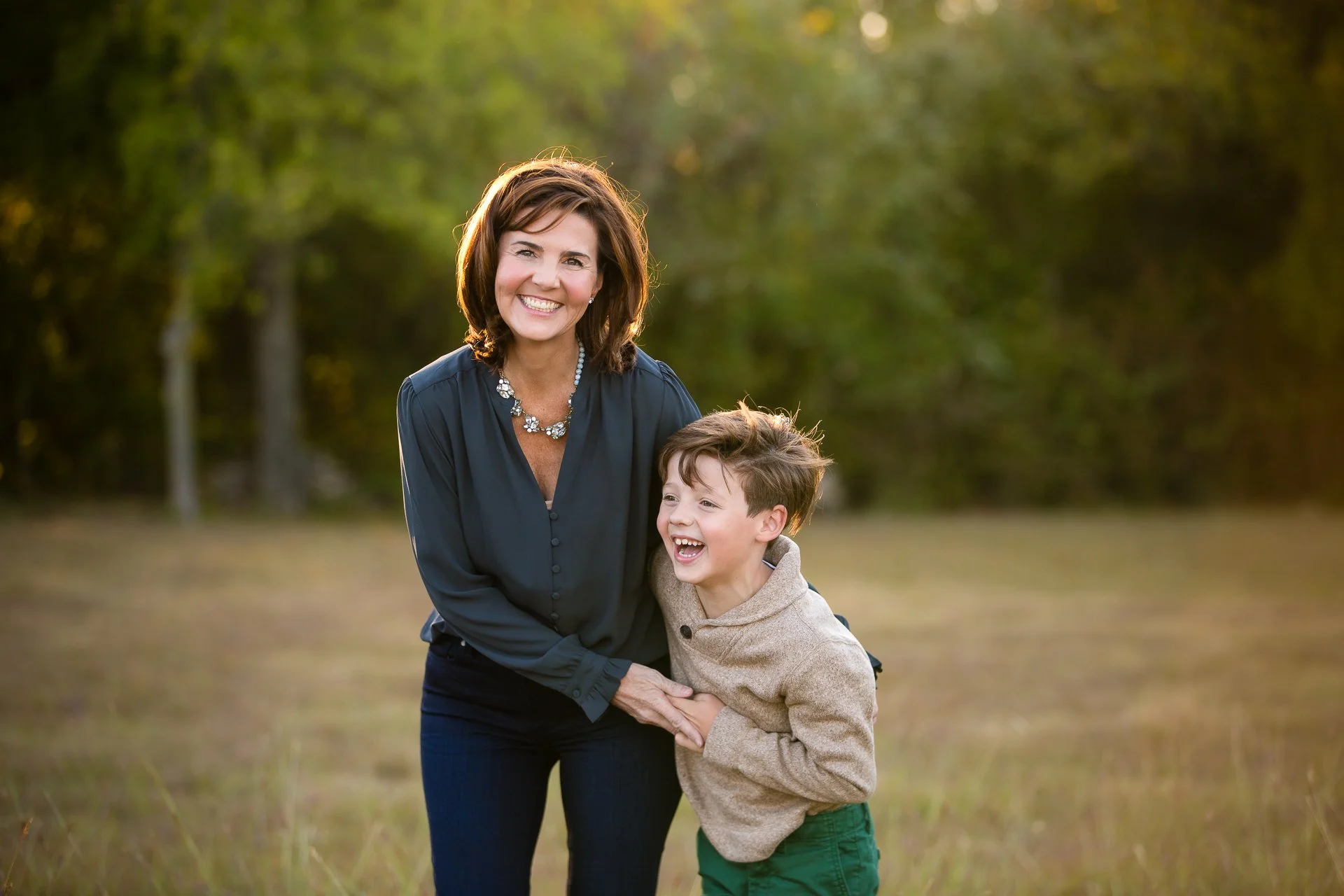 Color-lifestyle-photo-of-a-mother-and-son-laughing-in-a-field-near-Colleyville-Texas.jpg