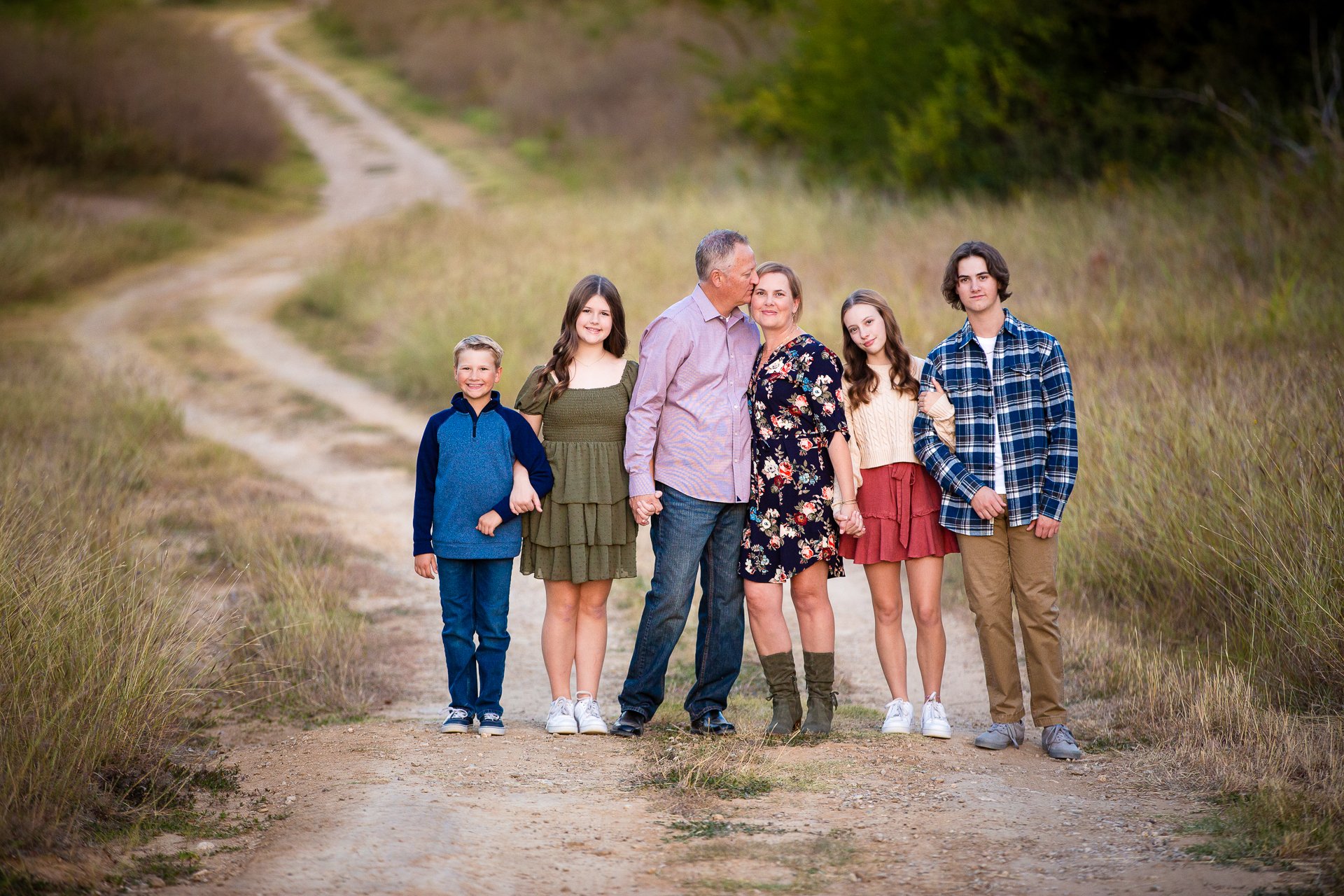 Colorful-image-of-a-family-standing-in-a-field-in-Trophy-Club-Texas.jpg
