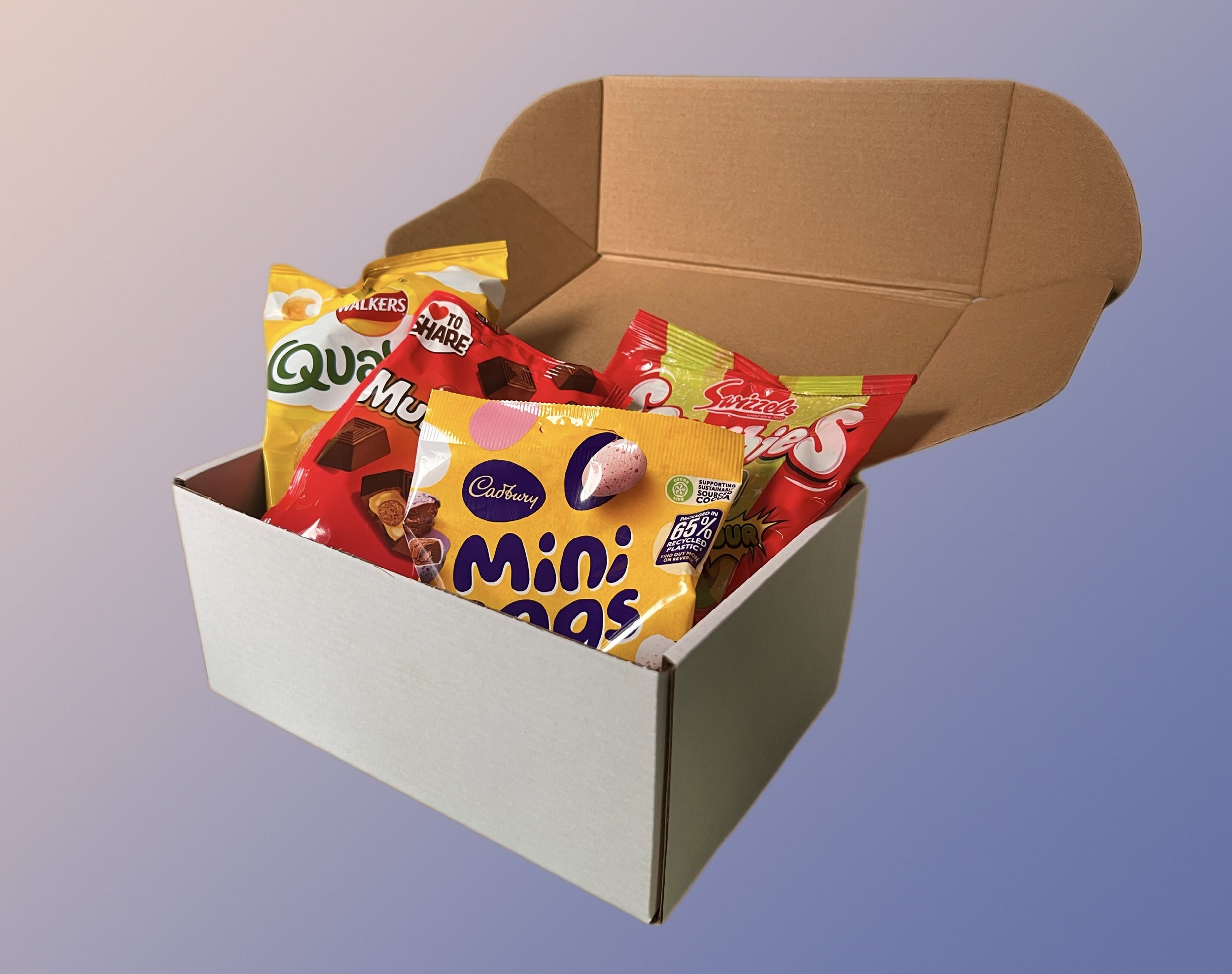 Open white box filled with various chocolate snack bags.