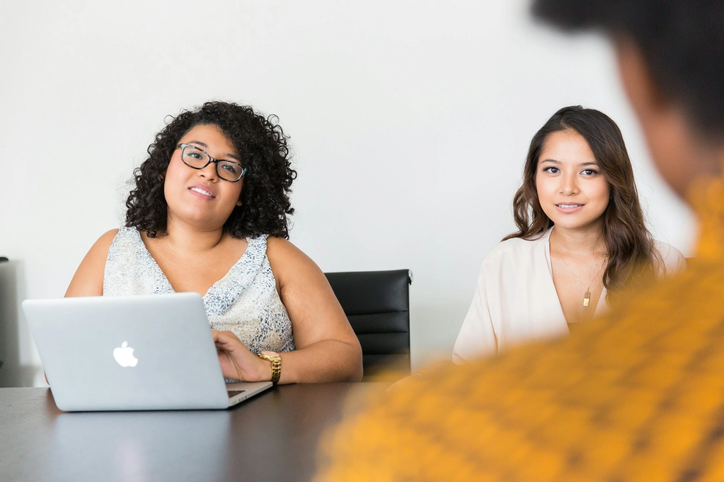 A woman reviewing job listings and career notes at a table, representing a career pivot into a new field without direct experience