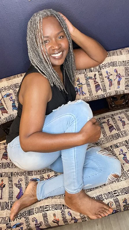 shawna curled up on couch smiling.