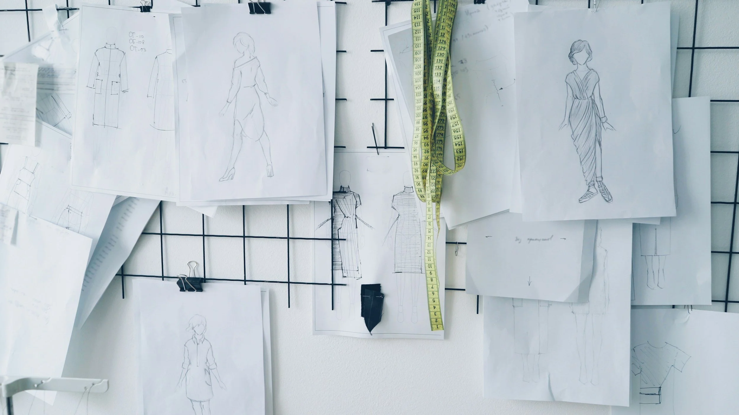 sketches and measuring tape for apparel design