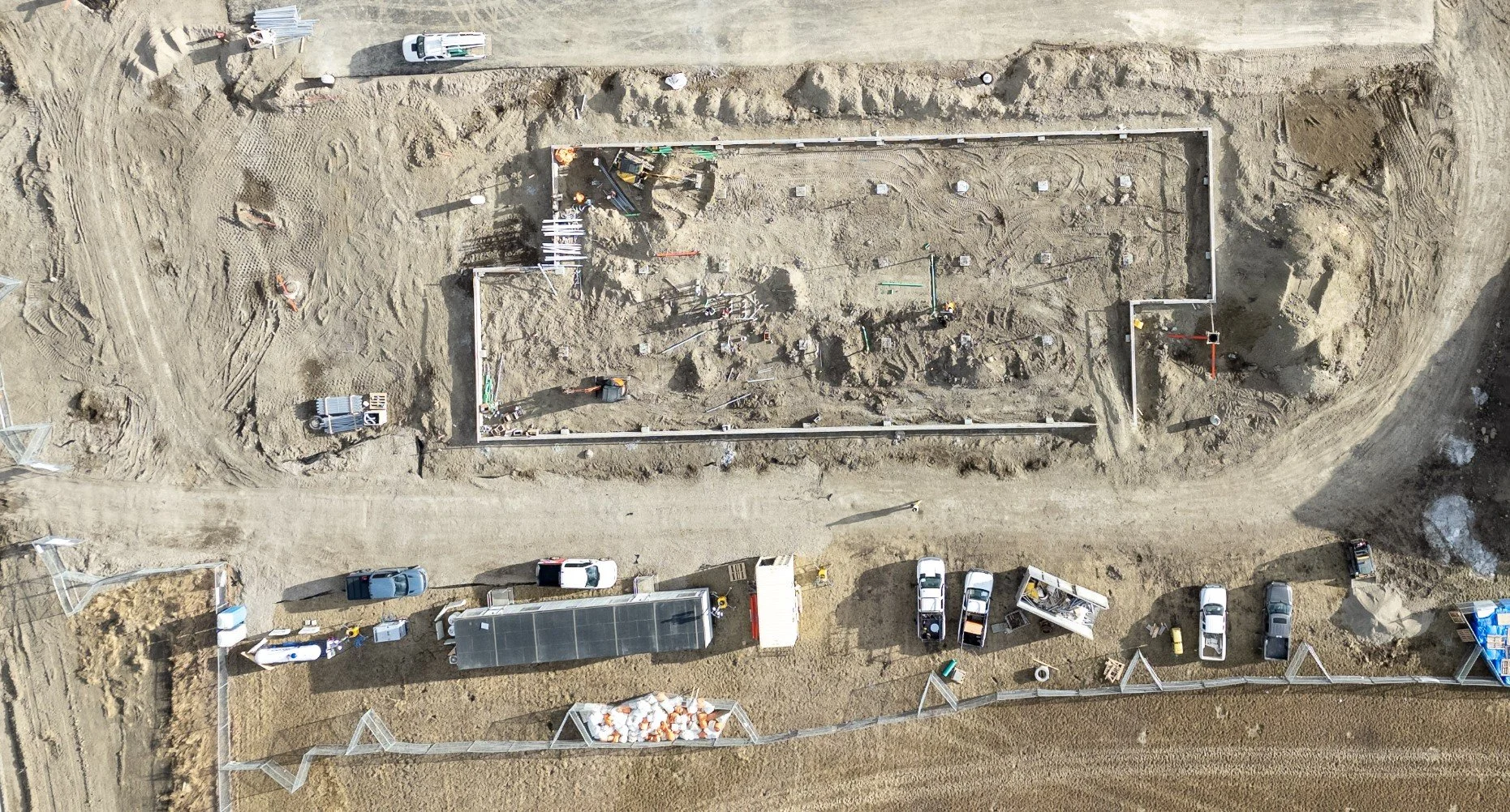 Perspective distortion in a raw aerial photo. Note the “lean” of the buildings, fencing and vehicles.