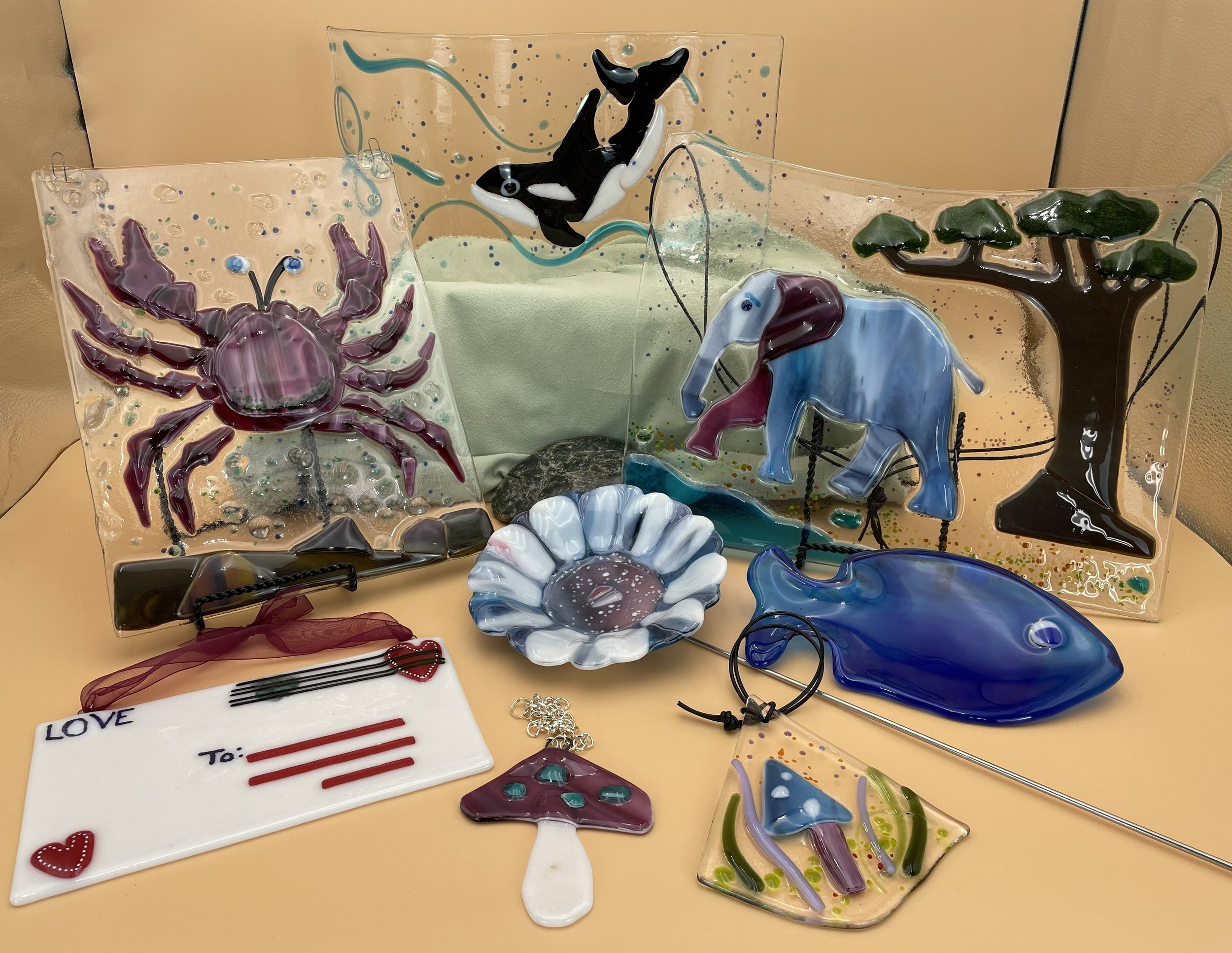 An assortment of our beautiful fused glass art, garden pieces and sun catchers