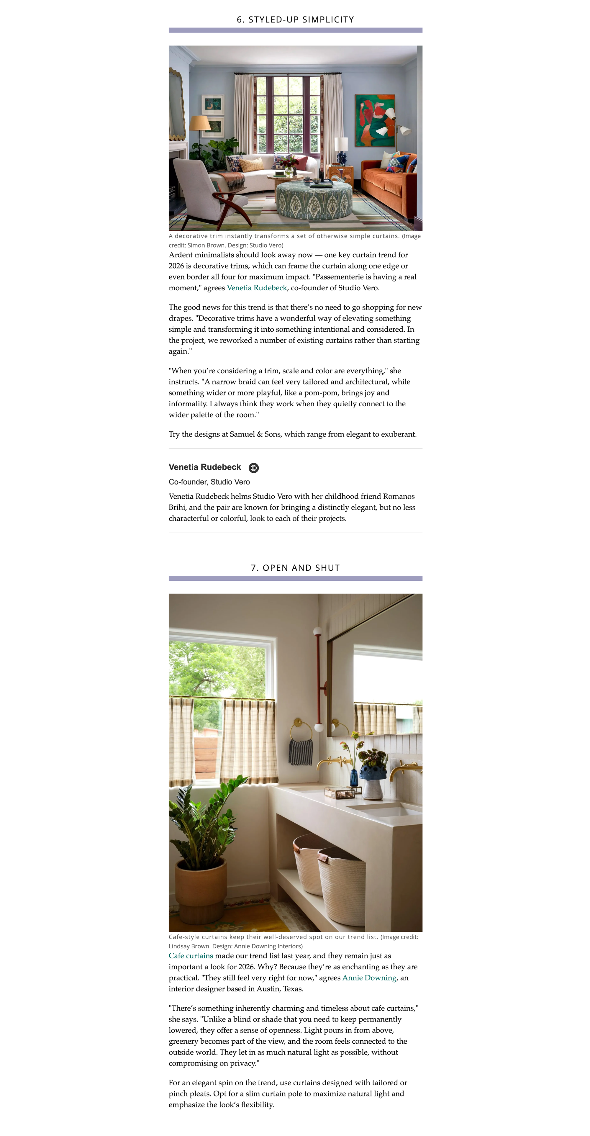 Living room with blue walls, large window with curtains, and colorful artwork, featuring sofa, armchair, coffee table, and various decorative items.