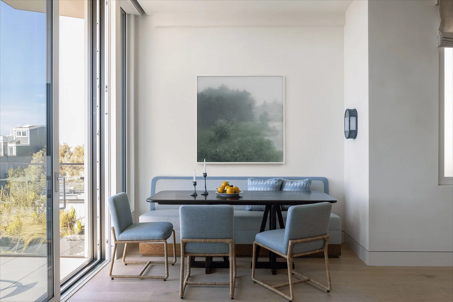 Our cozy Russian Hill breakfast nook overlooks the Golden Gate Bridge and San Francisco Bay - what a view to start the day!

Chairs by @robertkime surround a custom oak table, while a vintage sconce from @urbanelectric casts a warm glow. Artwork by K