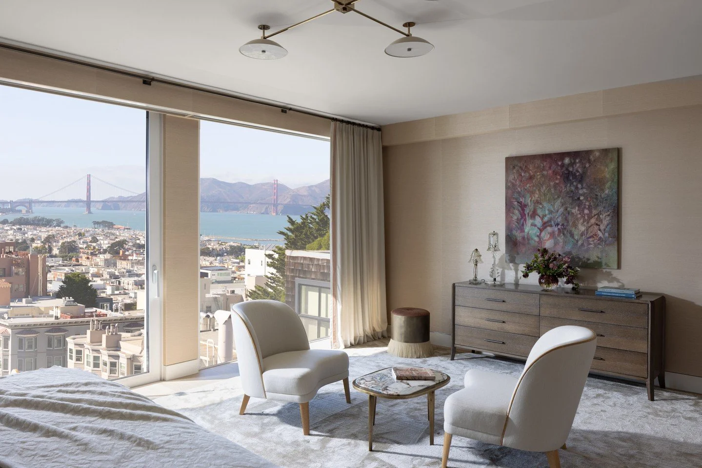 The primary bedroom was designed in a spare style, to keep the focus on the unobstructed views of the Golden Gate Bridge through the floor-to-ceiling windows. ⁠
⁠
#mareaclarkinteriors