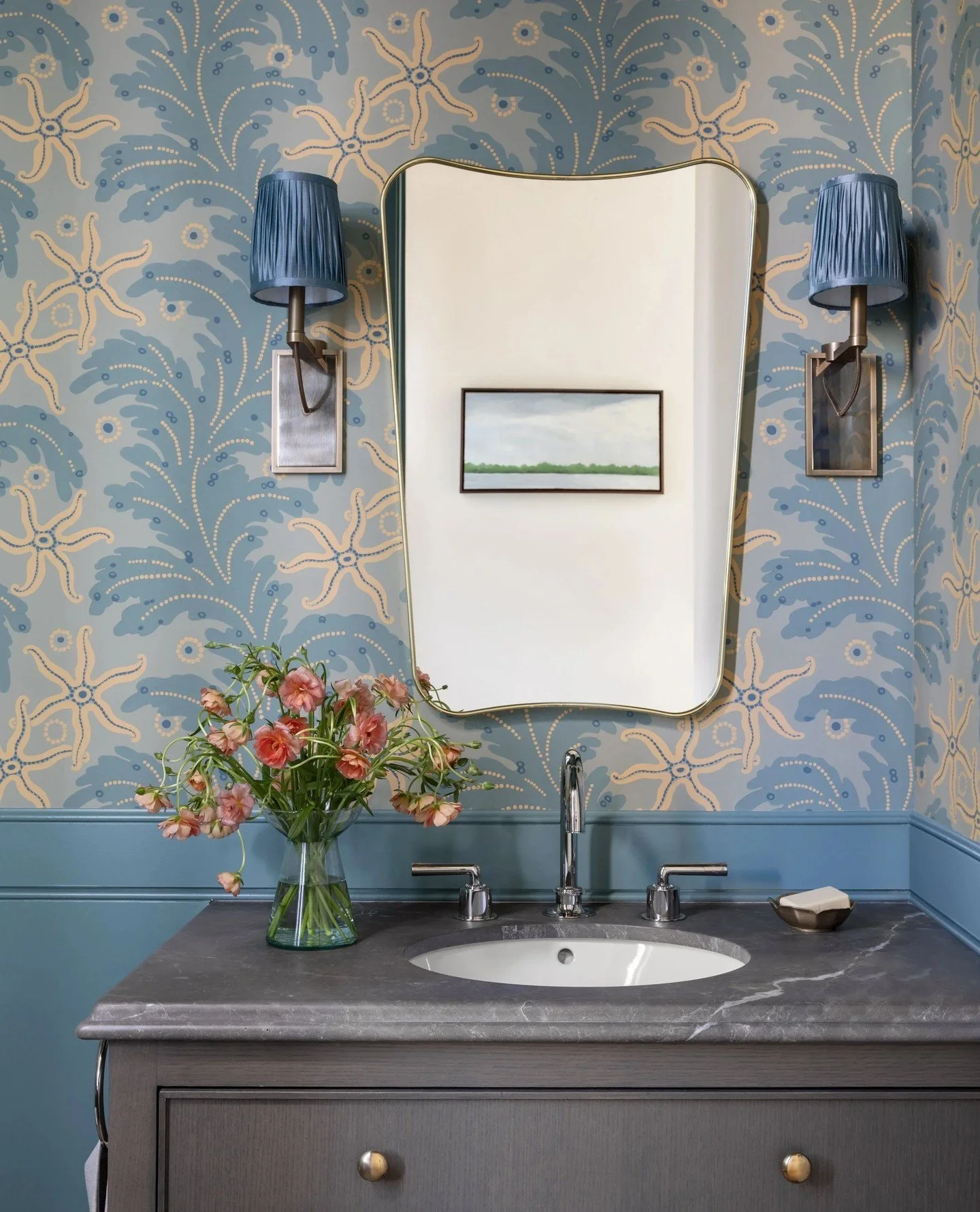 Our Russian Hill powder room. ⁠
⁠
A Gubi reedition of a mirror designed by Gio Ponti for Fontana Arte in 1933 forms a focal points.⁠
⁠
The wallpaper reimagines French Art Deco and Wiener Werkst&auml;tte patterns from the 1910s, and the brass sconces 