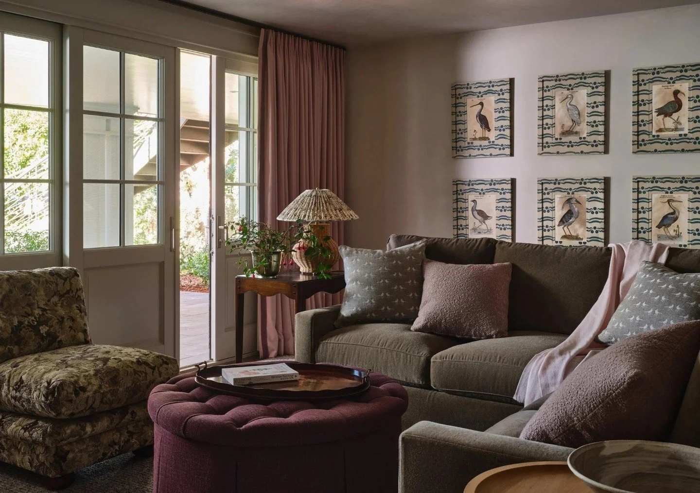 In the family room, a grid of jewel-toned Casa Gusto frames in an avian series anchors the wall, a natural touch that nods to the outdoors beyond. ⁠
⁠
#carmelbythesea