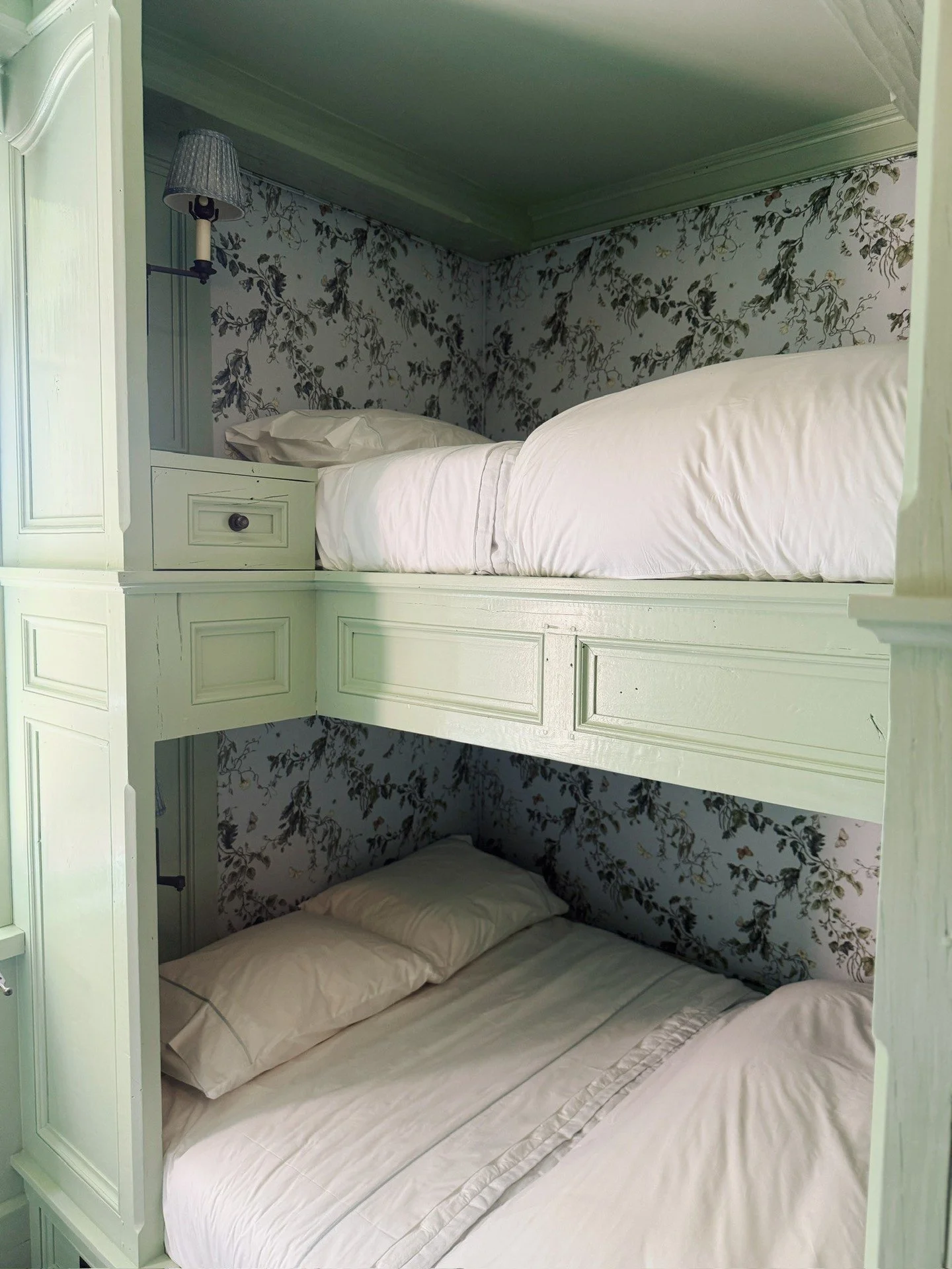 Bunk rooms are the best rooms.⁠
⁠
Designed for sleepovers, story time, and endless imagination, this cozy retreat proves that kid-friendly can still be beautifully designed. ⁠
⁠
Thoughtful millwork, layered lighting, and charming floral wallpaper com