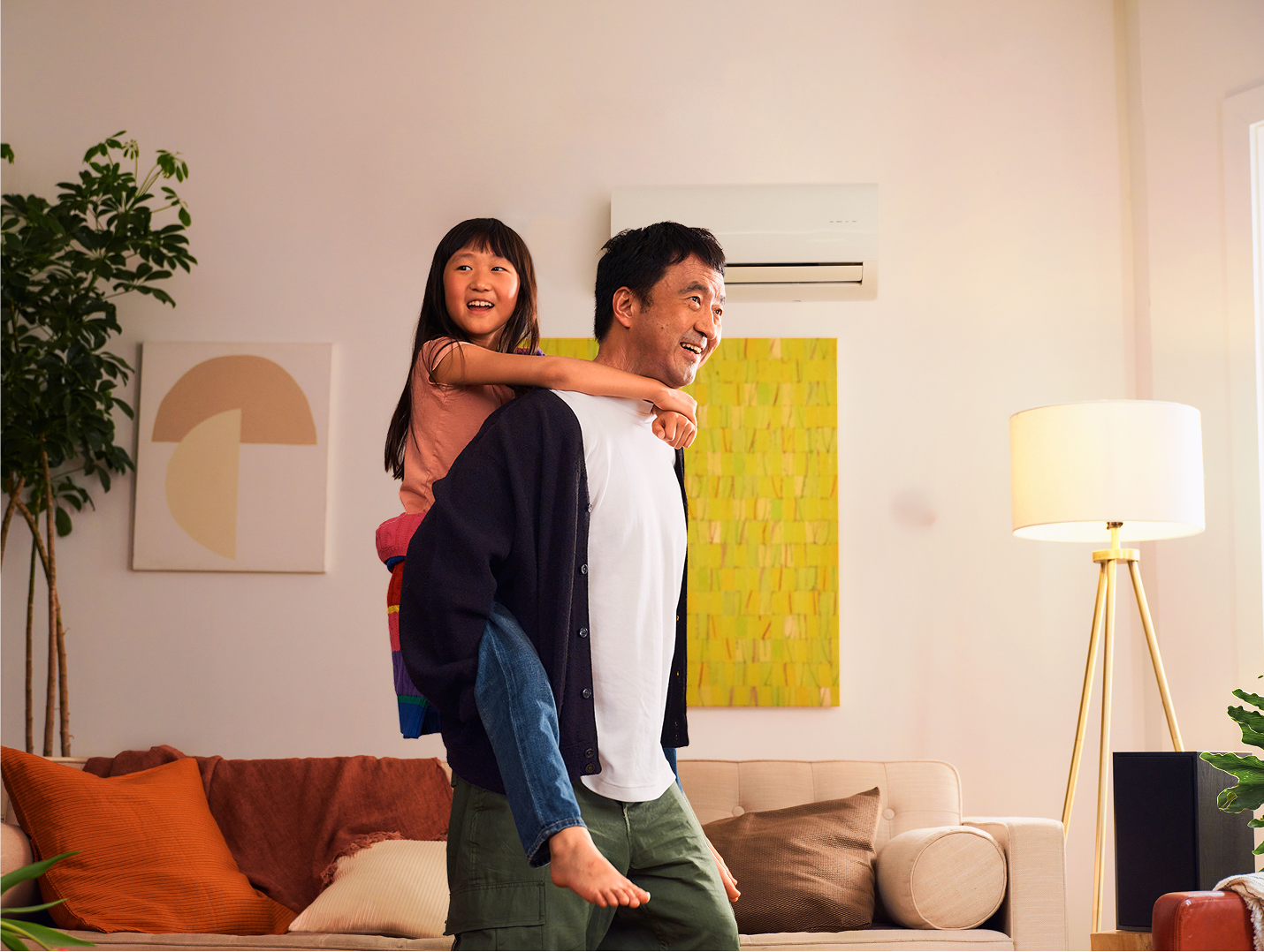 Asian father and daughter in living room