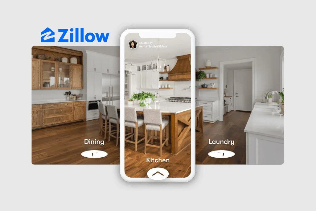 Screenshot of a virtual home tour app showing a modern kitchen, with options to view dining and laundry areas, and a central view of the kitchen with a kitchen island and bar stools, with Zillow logo in the top left corner.