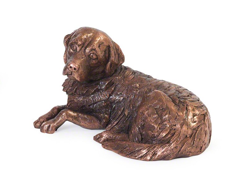 A copper plated sculpture of a resting Golden Retriever, featuring intricate fur details and a lifelike expression. The dog lies on its side.