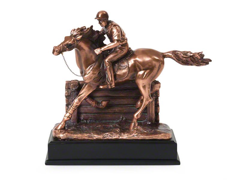 A detailed copper plated statue of a jockey riding a horse, showcasing dynamic motion in front of a jump with a glossy black base.