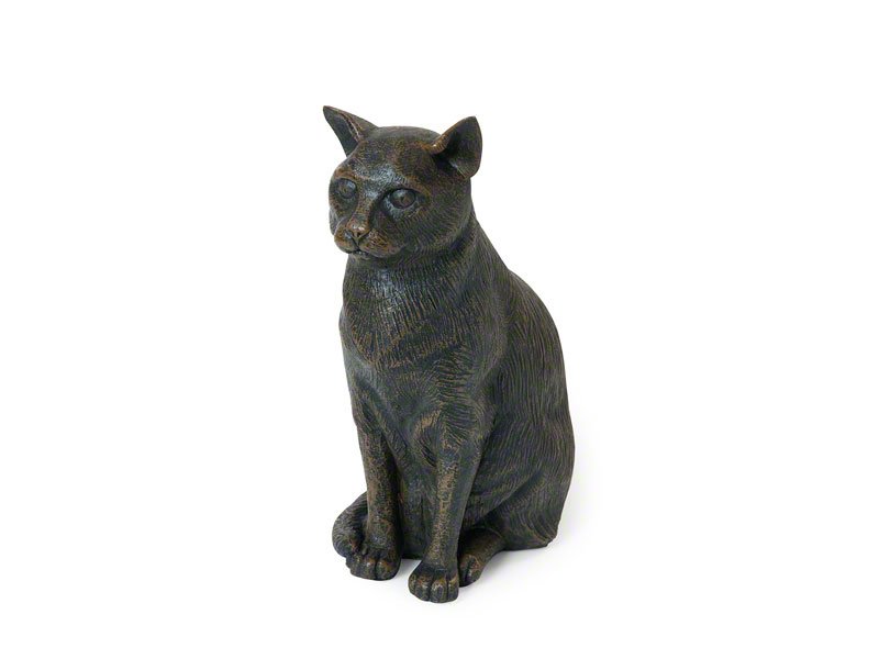 A cast resin cat figurine urn with a bronze finish with detailed features and textured fur, showcasing a lifelike expression and posture.