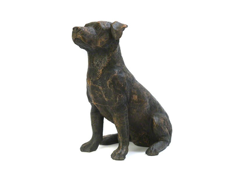 A cast resin Jack Russell figurine urn with a bronze finish, gazing upward, showcasing detailed features and a textured surface.