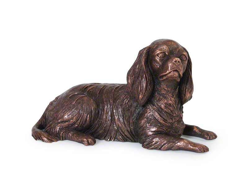 A copper plated sculpture of a resting Cavalier King Charles Spaniel with lifelike fur texture and expressive features, showcasing the artist's attention to detail.