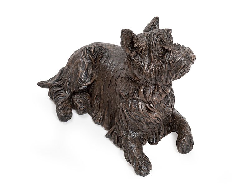 A cast resin West Highland Terrier figurine urn, with a bronze finish, with a textured coat, showcasing a realistic expression and posture.