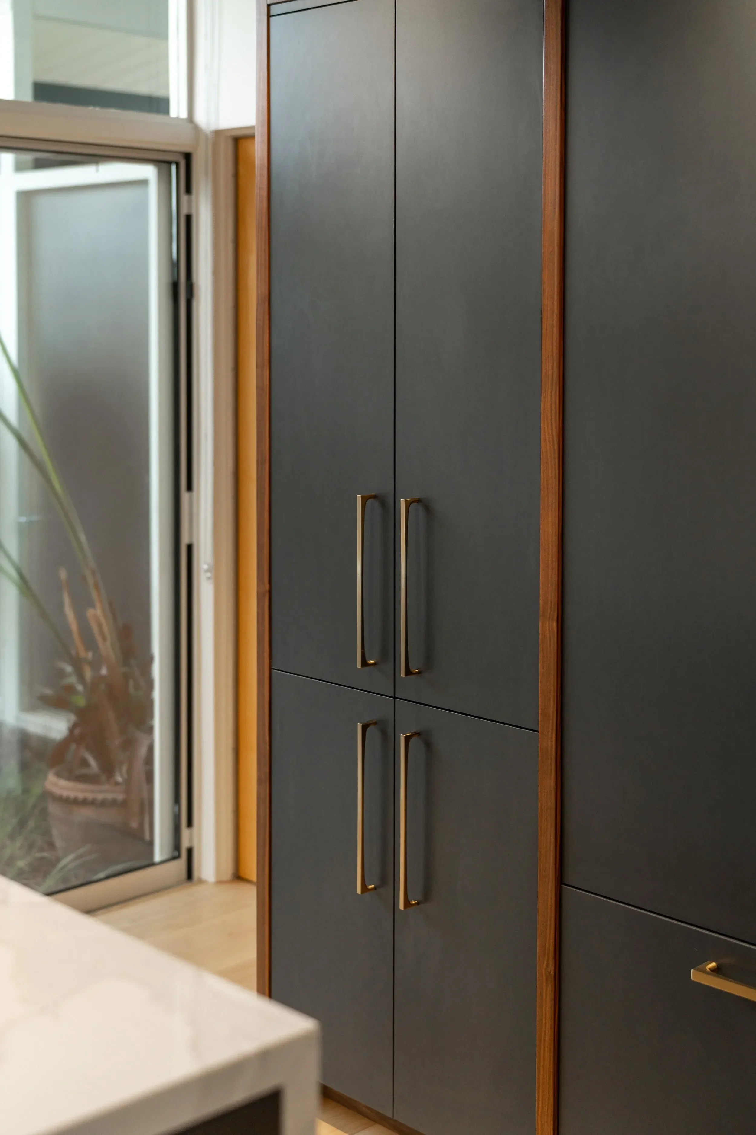 a-stainless-steel-refrigerator-with-a-black-door (1).webp