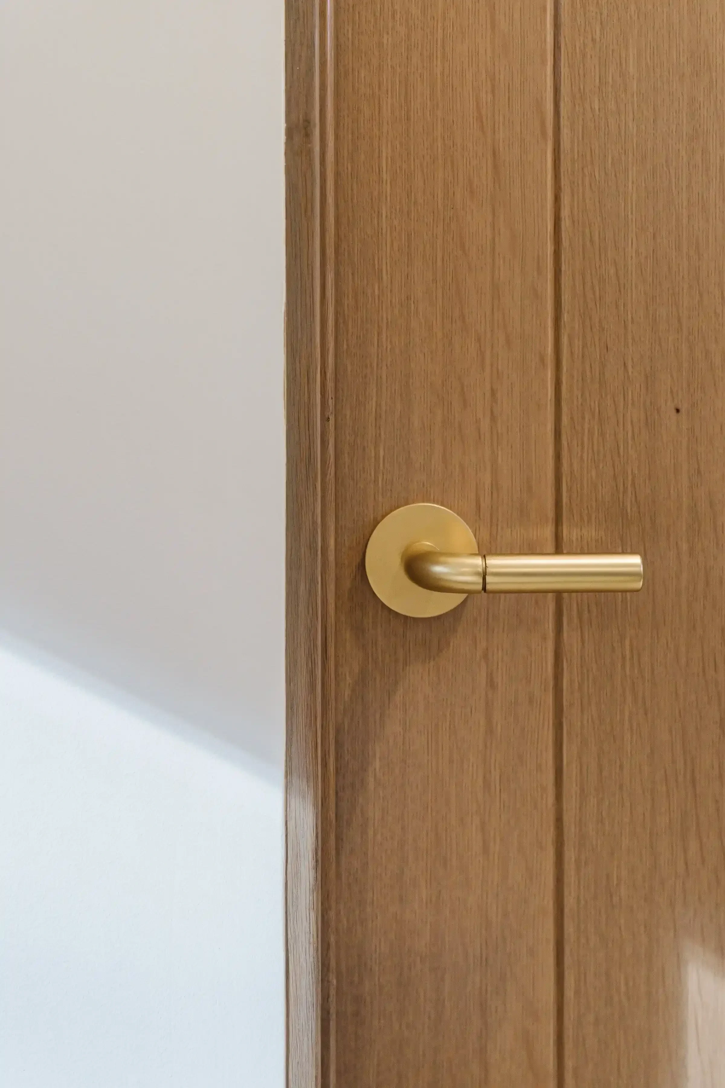 a-wooden-door-with-a-wooden-handle-and-a-wooden-wall.webp