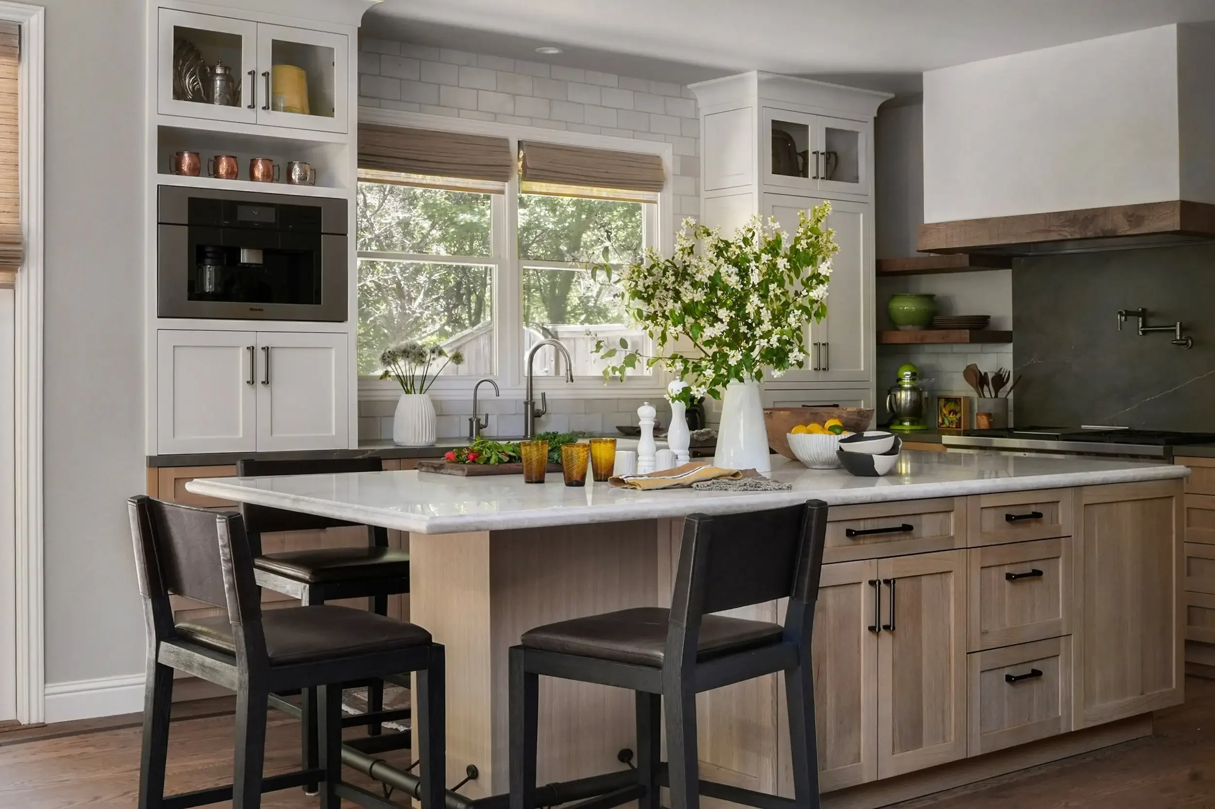 a-kitchen-with-a-sink-a-table-and-a-microwave.webp