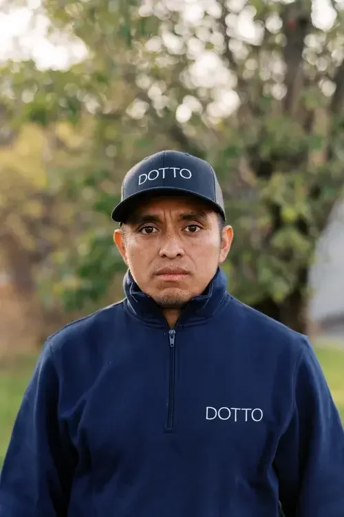 A man in a blue shirt and a blue hat