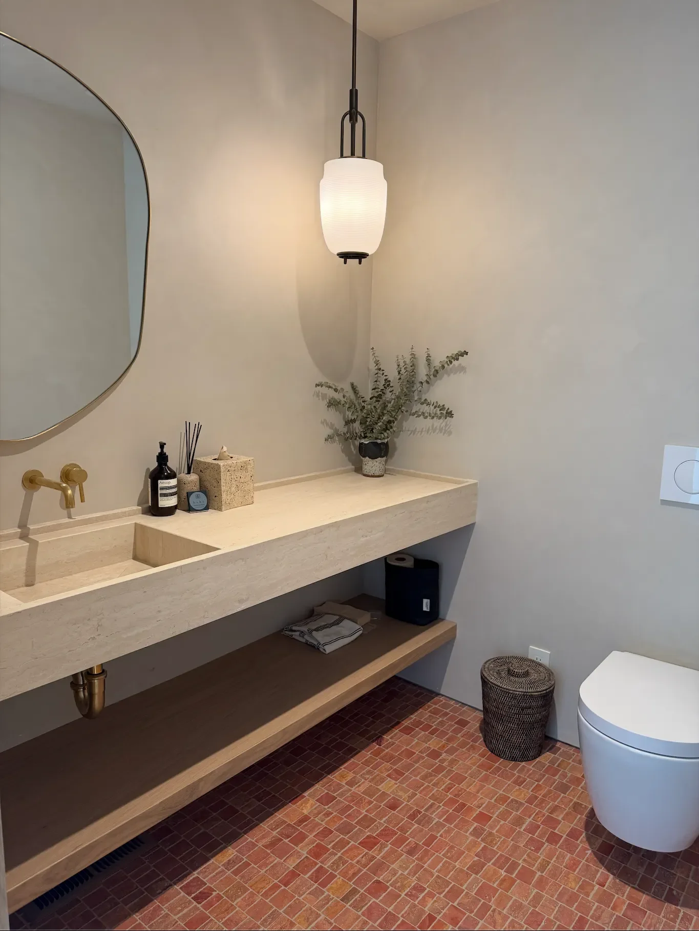 a-bathroom-with-a-sink-mirror-and-a-toilet