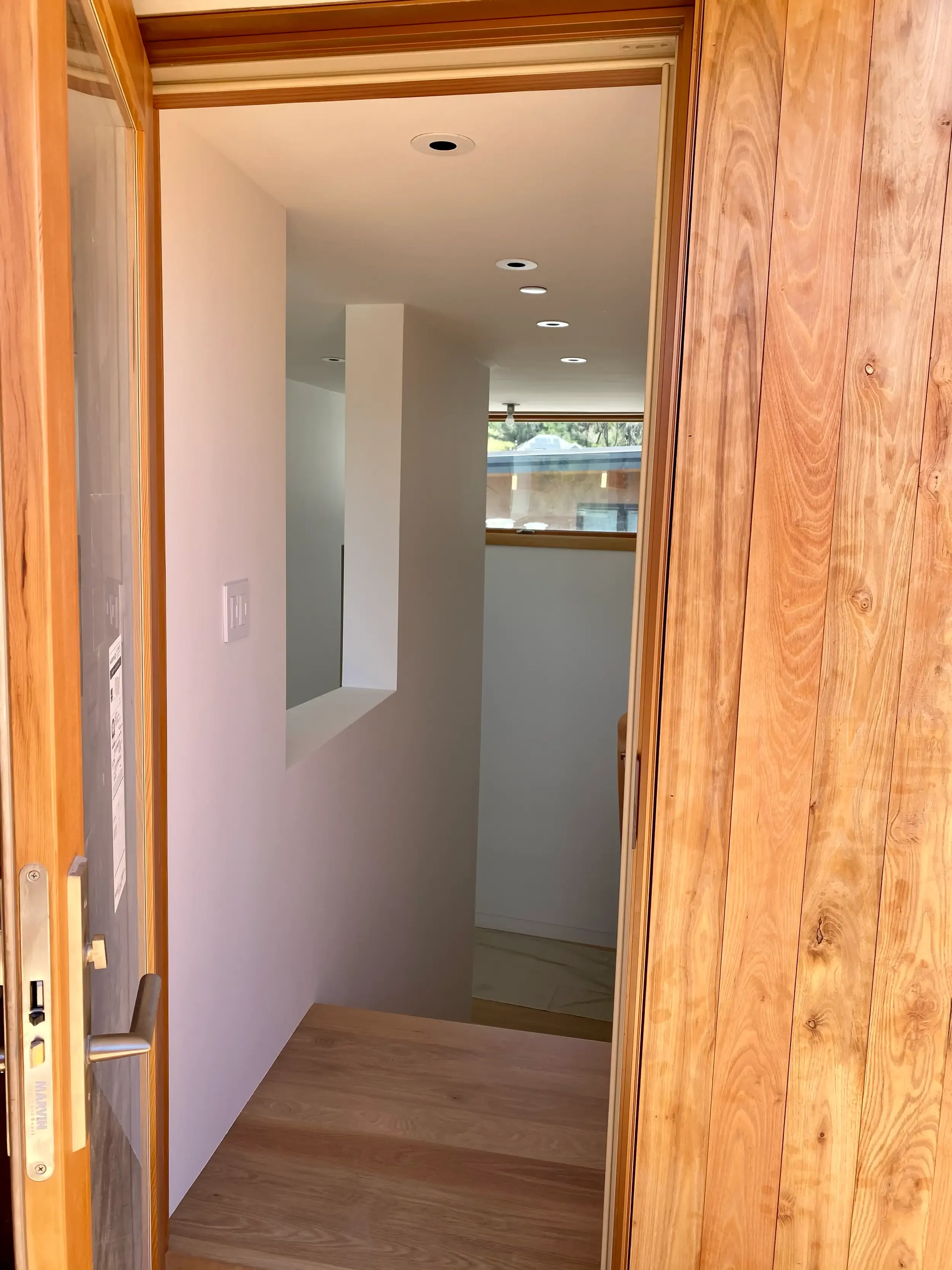 a-room-with-a-door-open-and-a-wall-with-a-wooden-floor