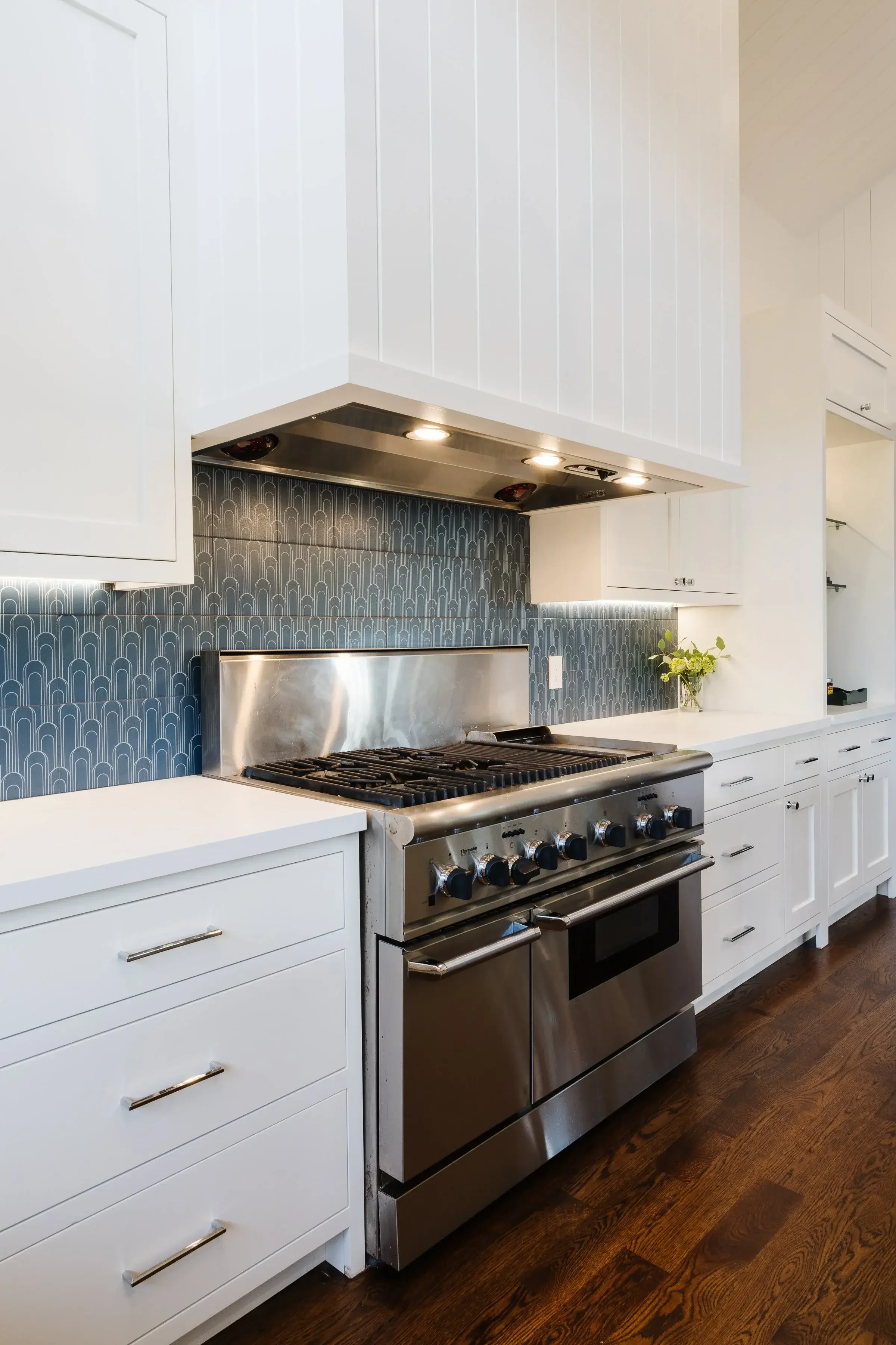 A kitchen with a stove top oven and a sink