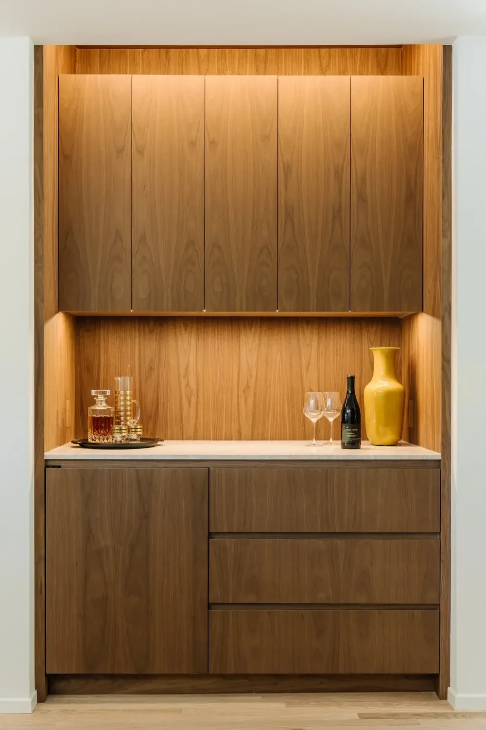 A wooden cabinet with a vase on top of it