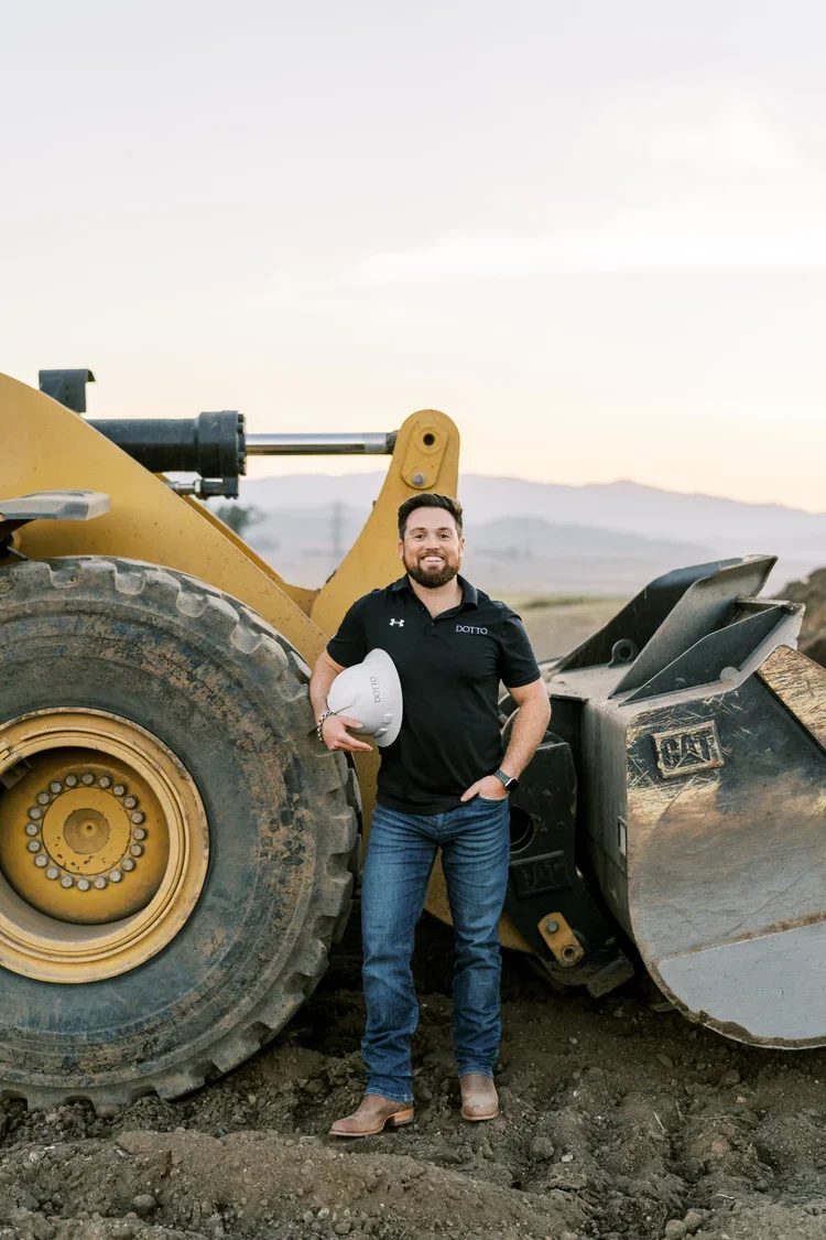 Man standing next to a dirt field at a construction site