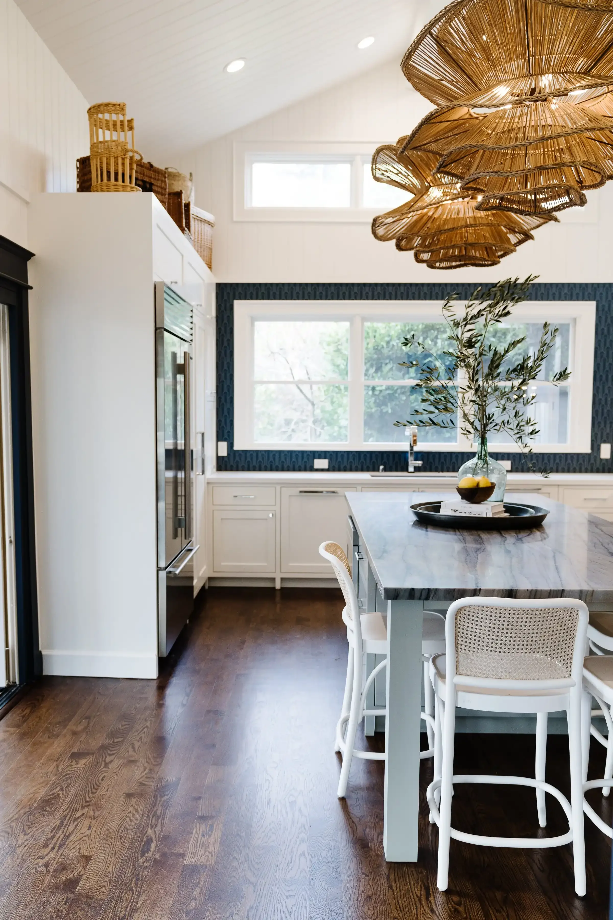 a-kitchen-with-a-table-and-a-large-window.webp