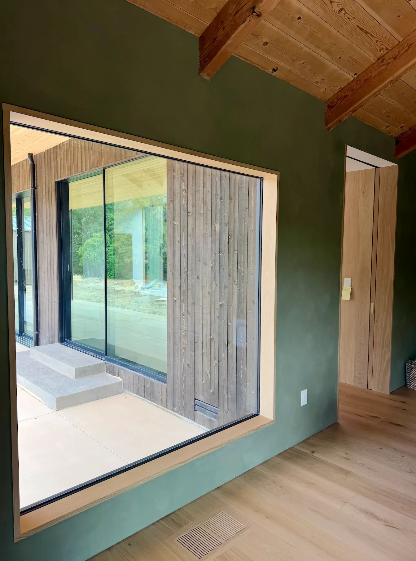 a-room-with-a-large-window-and-a-large-bed
