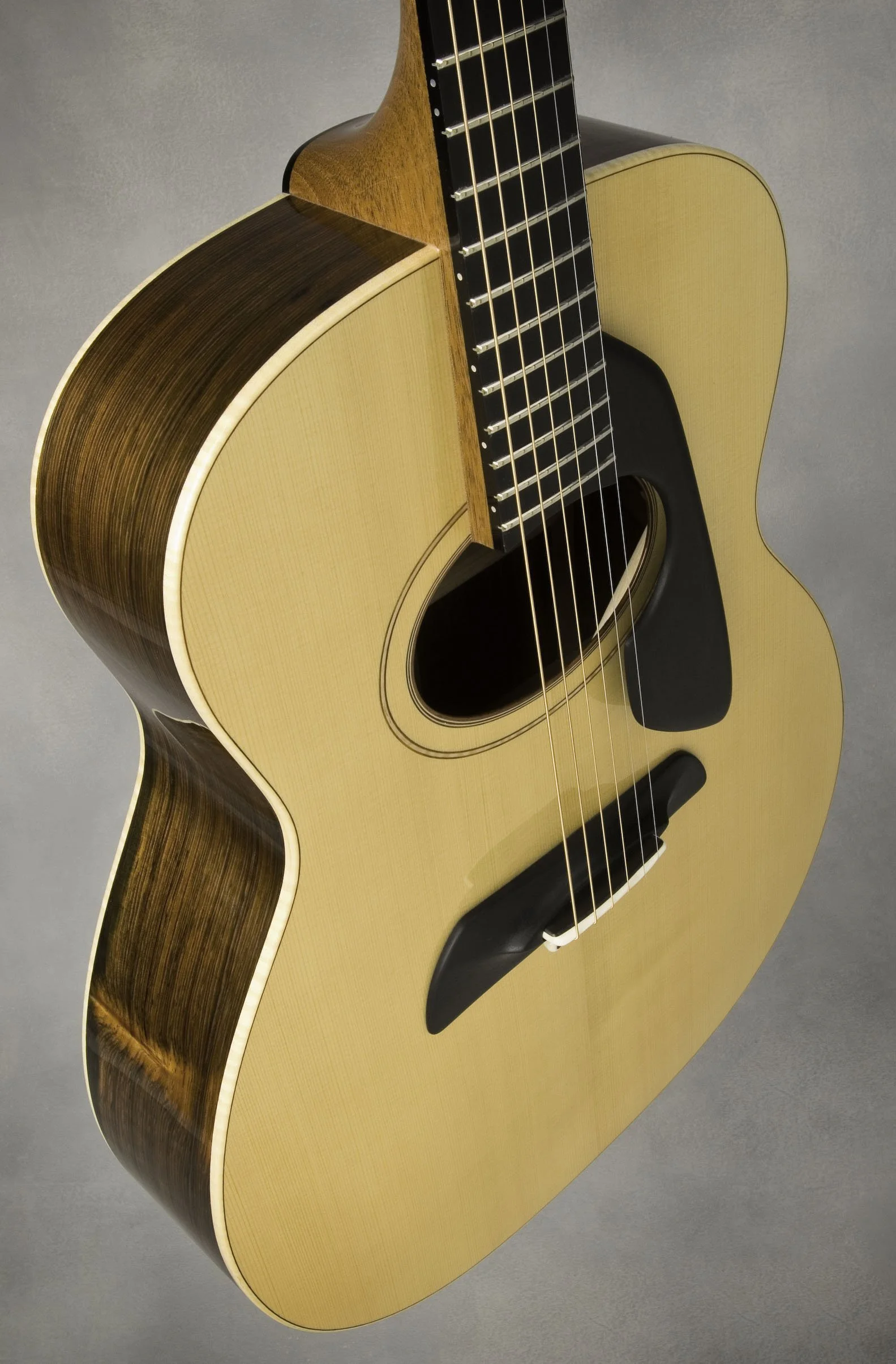 Modern acoustic guitar with unique soundhole design.