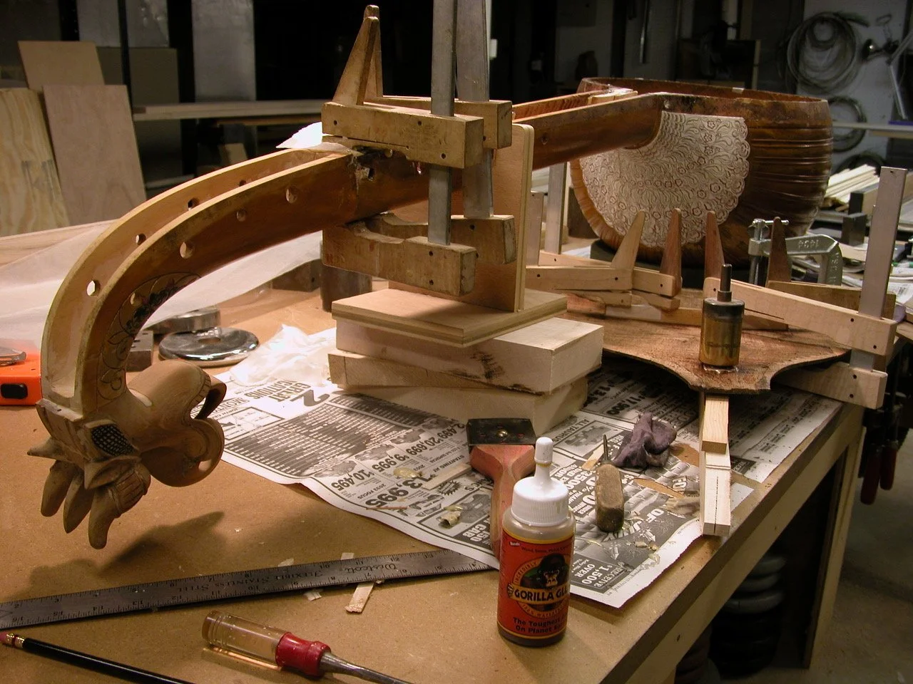 A woodworking project with clamps and tools on a workbench