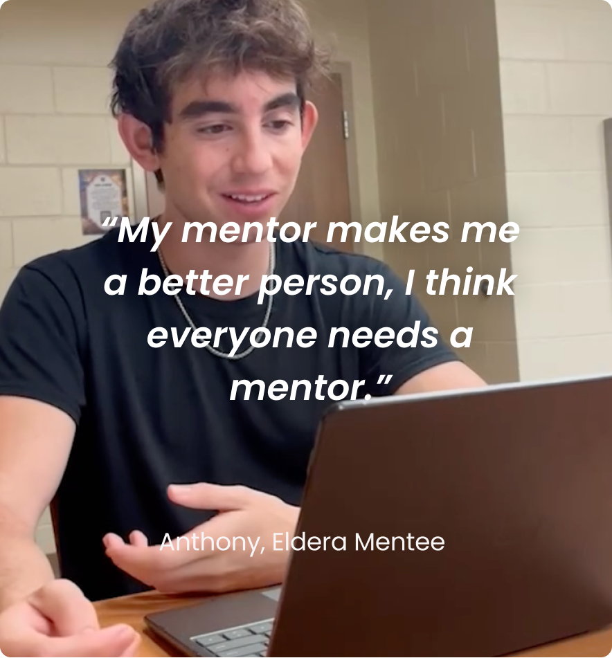 Young man sitting at a table with a laptop, smiling, and gesturing with his hands. The overlay text reads: "My mentor makes me a better person, I think everyone needs a mentor." Credit: Anthony, Eldera Mentee.