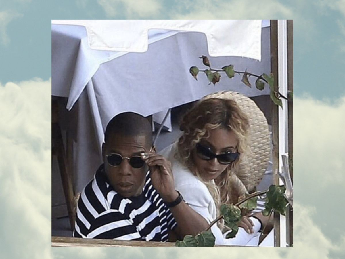 Beyoncé and Jay-Z wear sunglasses while giving a skeptical side-eye. Their image is layered on top of a photo of the sky.
