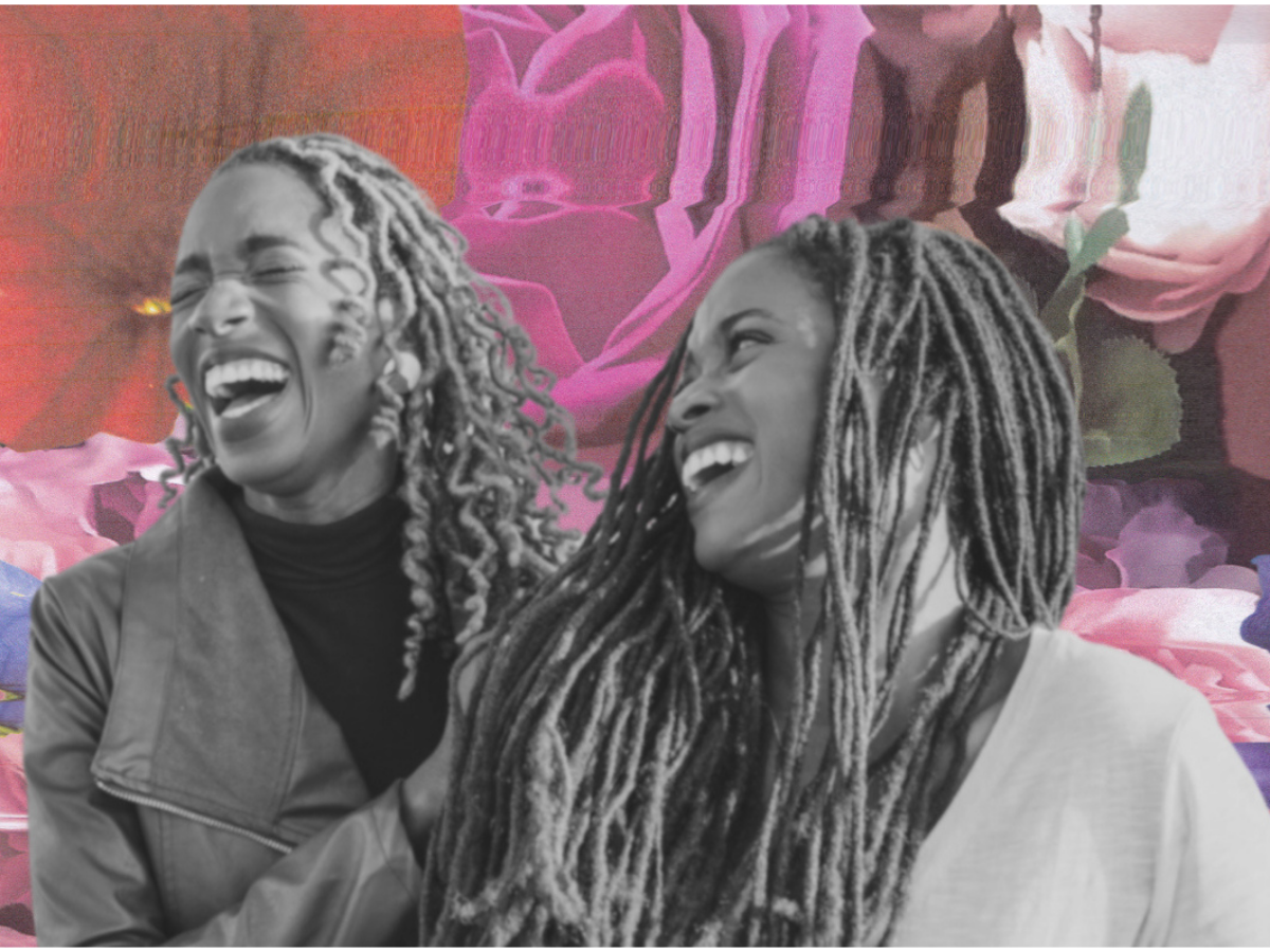 Two black people with locs laugh in front of a distorted red, white, and pink background.