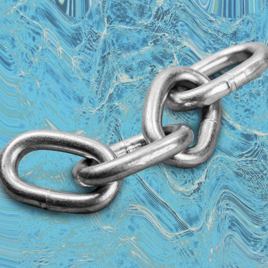 A silver chain is pictured against a marbled blue background.