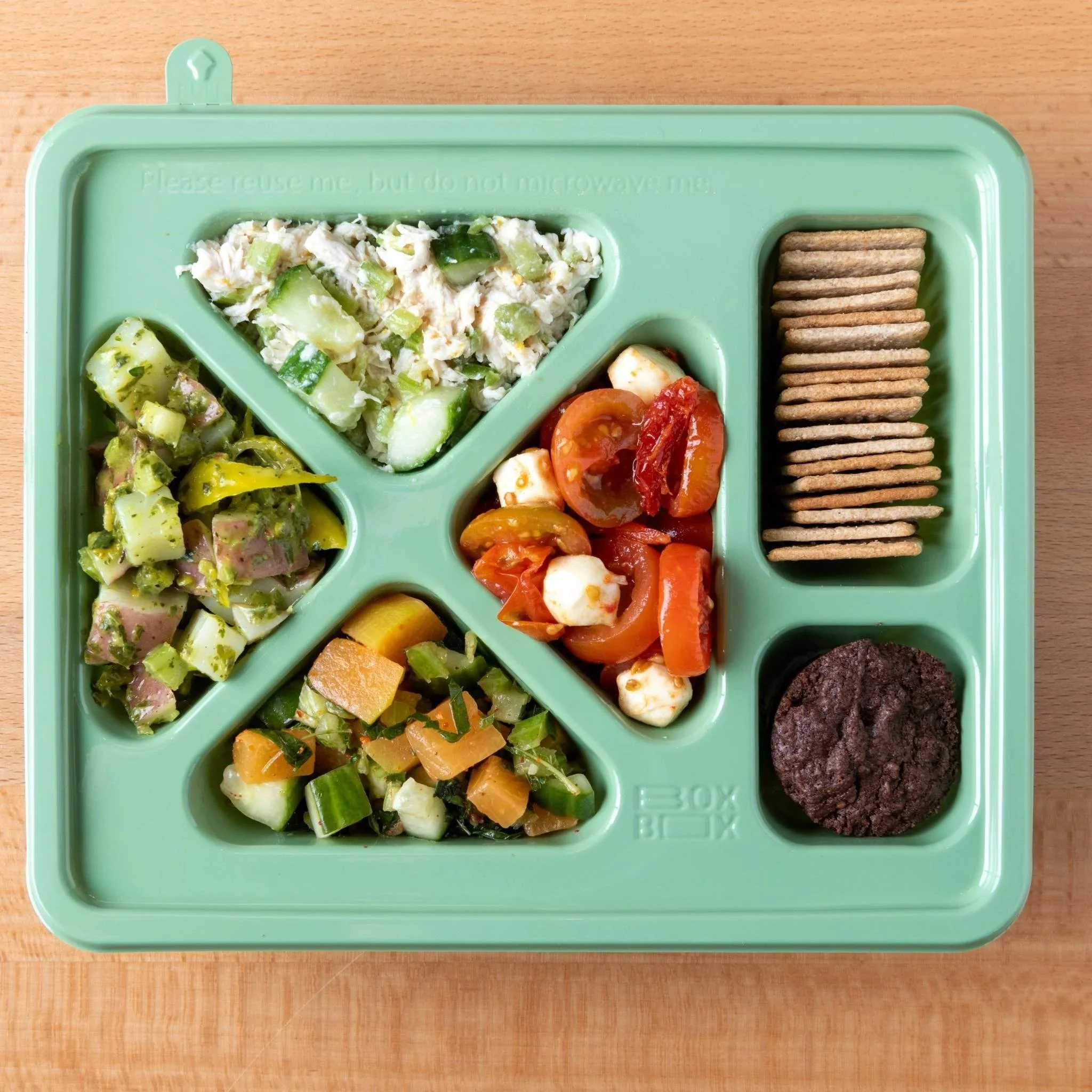 Bento Boxes feature 4 salads, crackers and brownie